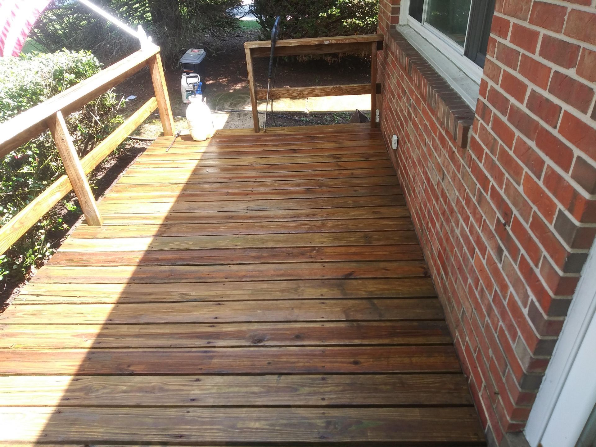A wooden deck next to a brick building