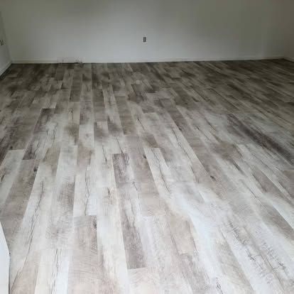 A room with a wooden floor and white walls.