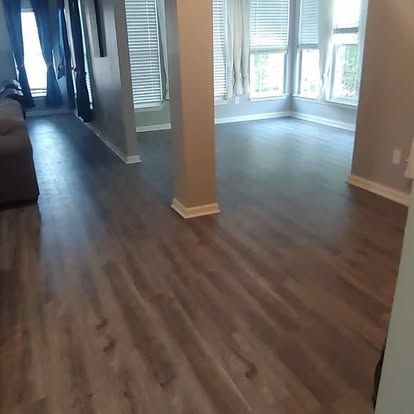 A living room with hardwood floors and a couch.