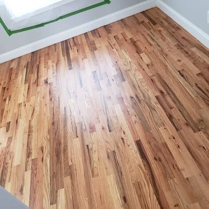 A room with a wooden floor and a window.