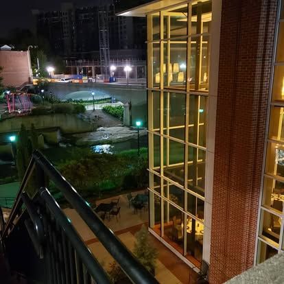 A large building with lots of windows is lit up at night