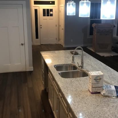 A kitchen with granite counter tops and two sinks