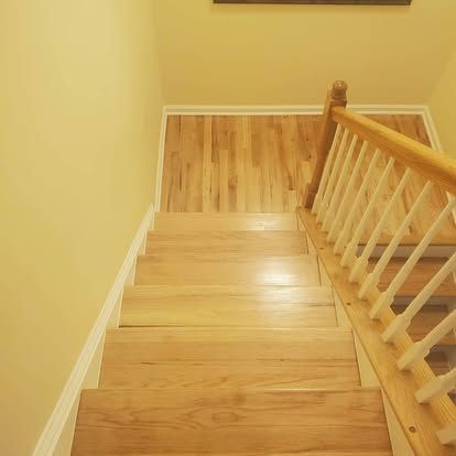 The stairs are made of wood and have a white railing.