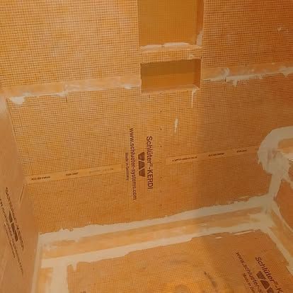 A room with a brick wall and a ceiling that is being remodeled.