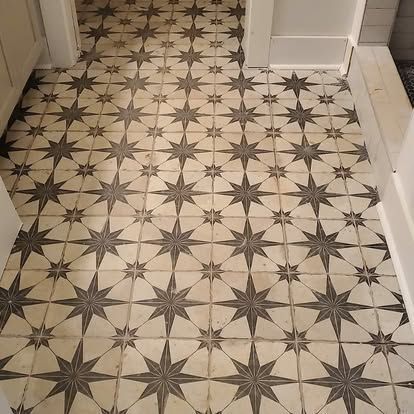 A tile floor with a pattern of stars on it.
