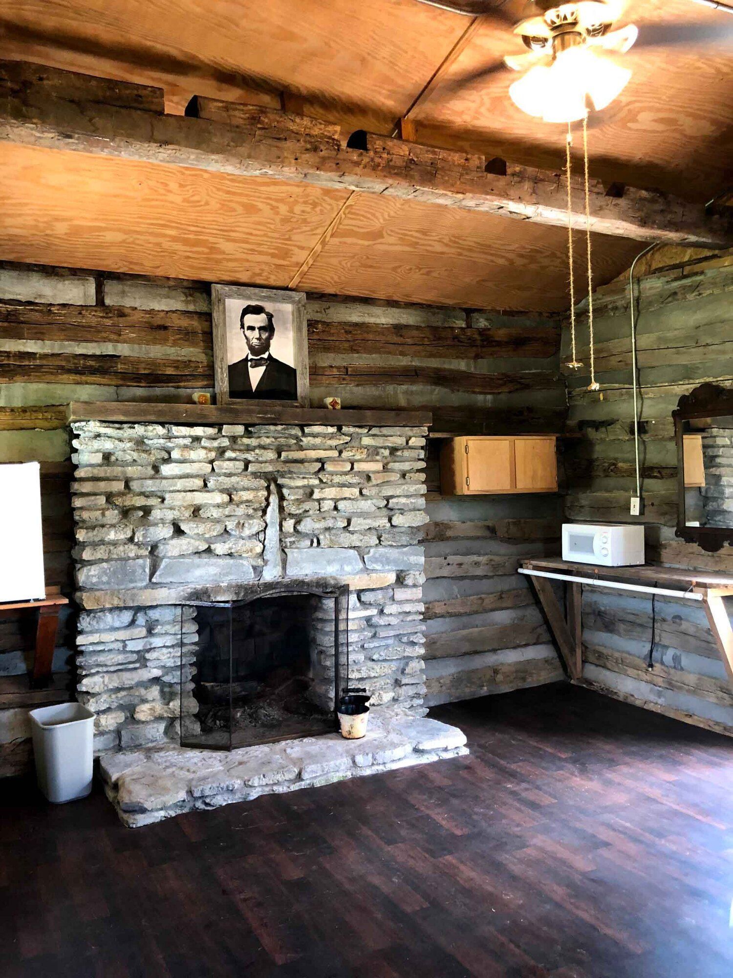 there is a picture of abraham lincoln on the fireplace .