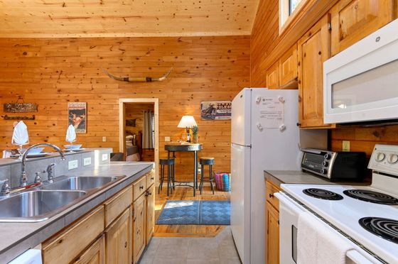 A kitchen with wooden cabinets and a white refrigerator