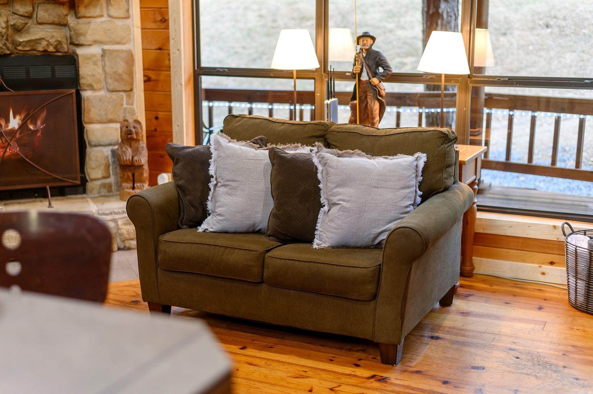 A couch is sitting in a living room next to a fireplace.