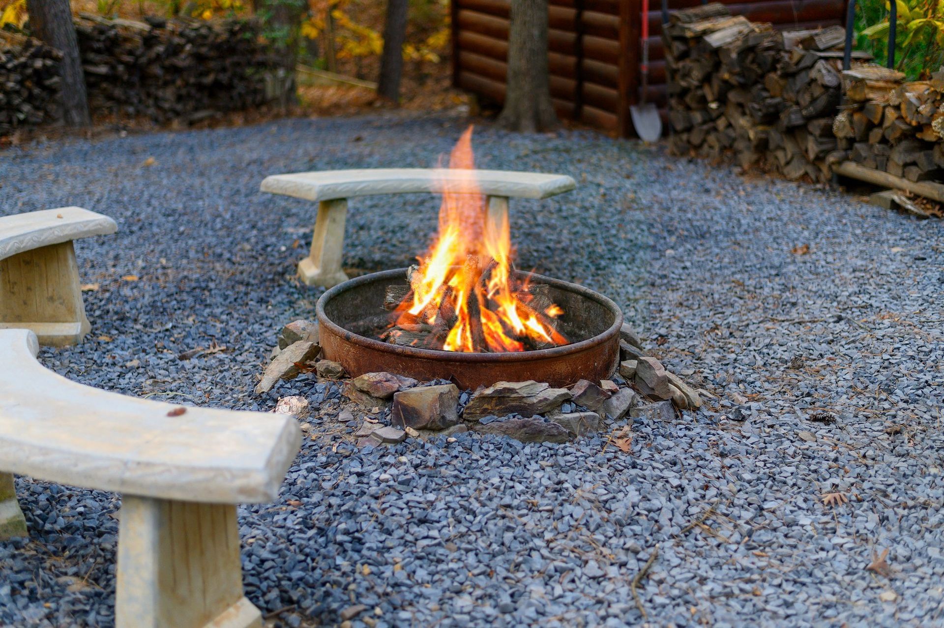 There is a fire pit in the middle of the gravel.