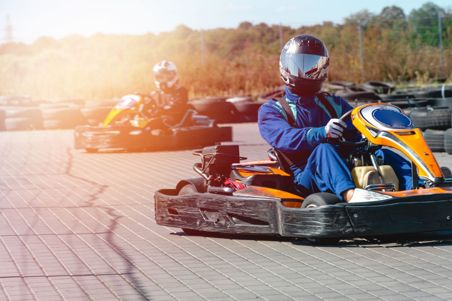 A man is riding a go kart on a track.