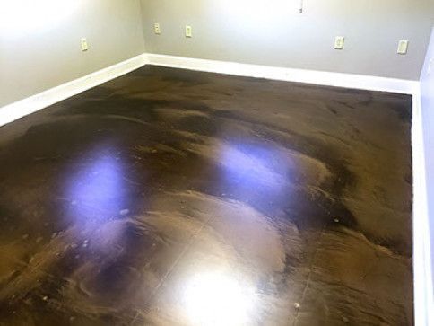 A room with a brown metallic floor and white trim.