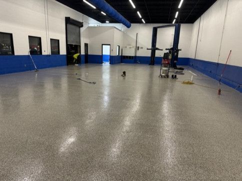 A large room with a gray floor and blue walls