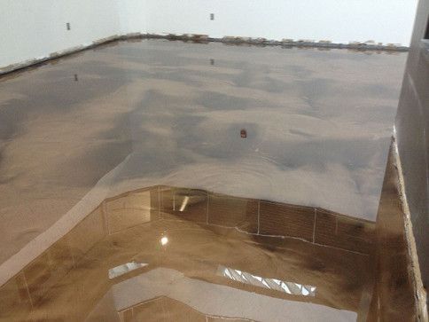 A room with a shiny metallic floor in it.