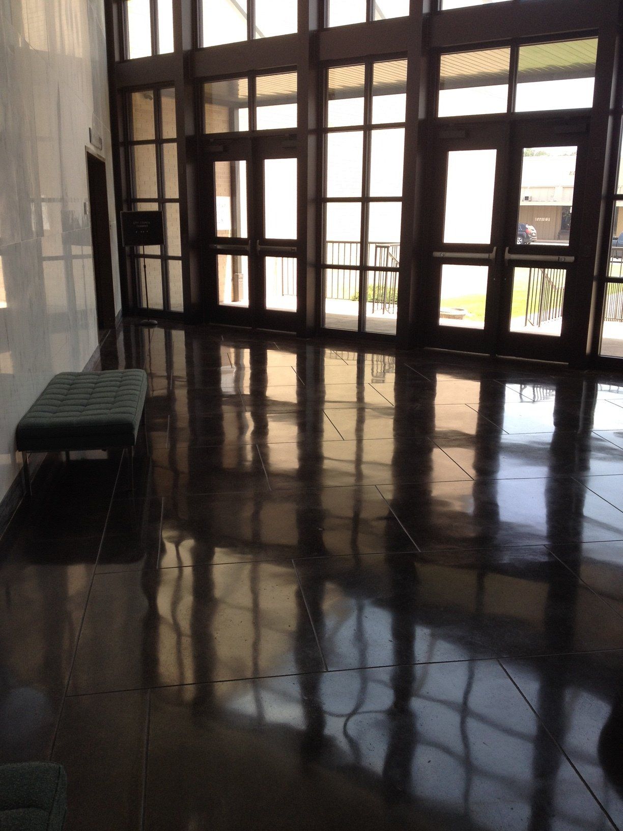 A large room with lots of windows and a bench