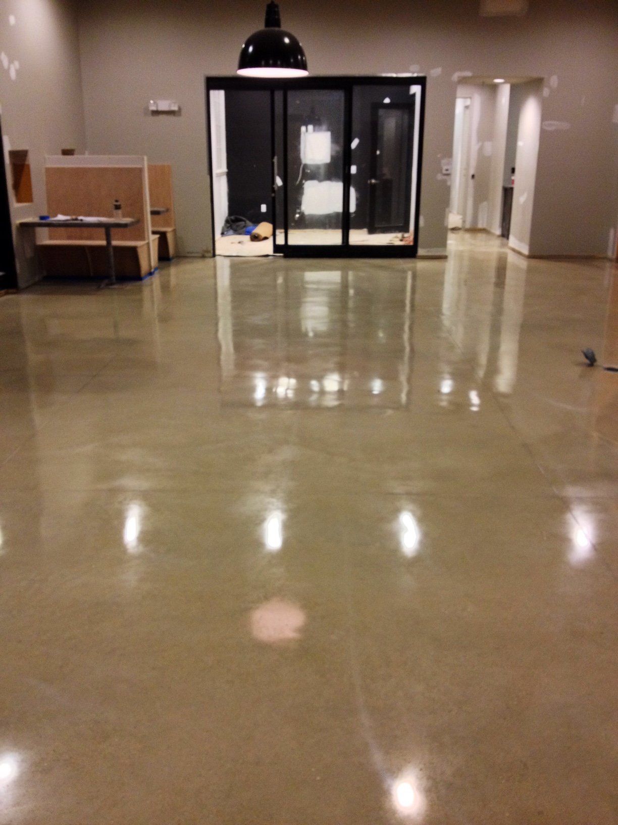 A large room with a shiny floor and a sliding glass door