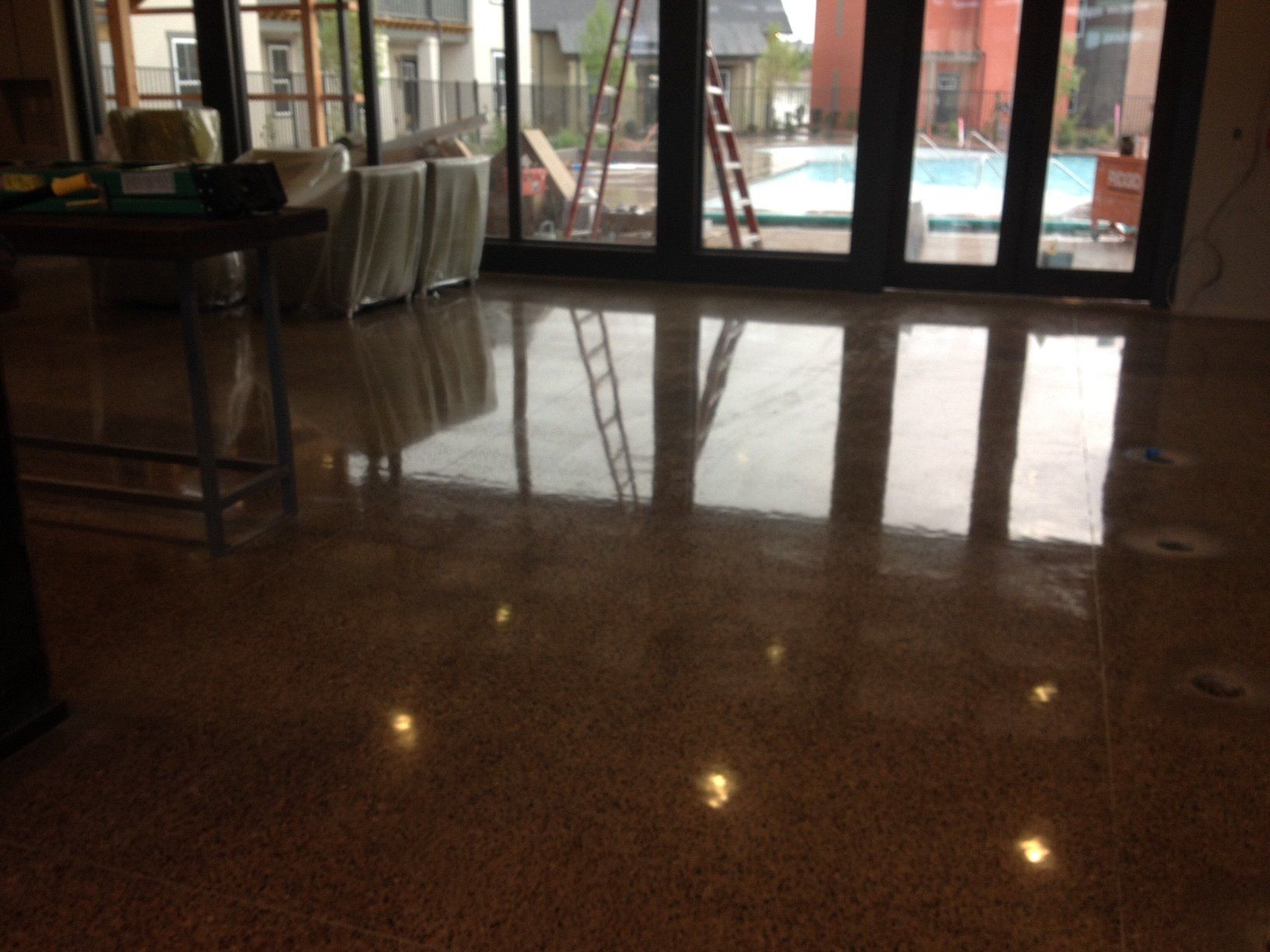 A living room with sliding glass doors leading to a pool