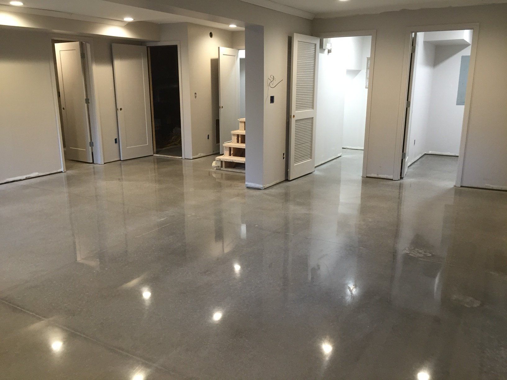 A large room with a shiny concrete floor and white walls