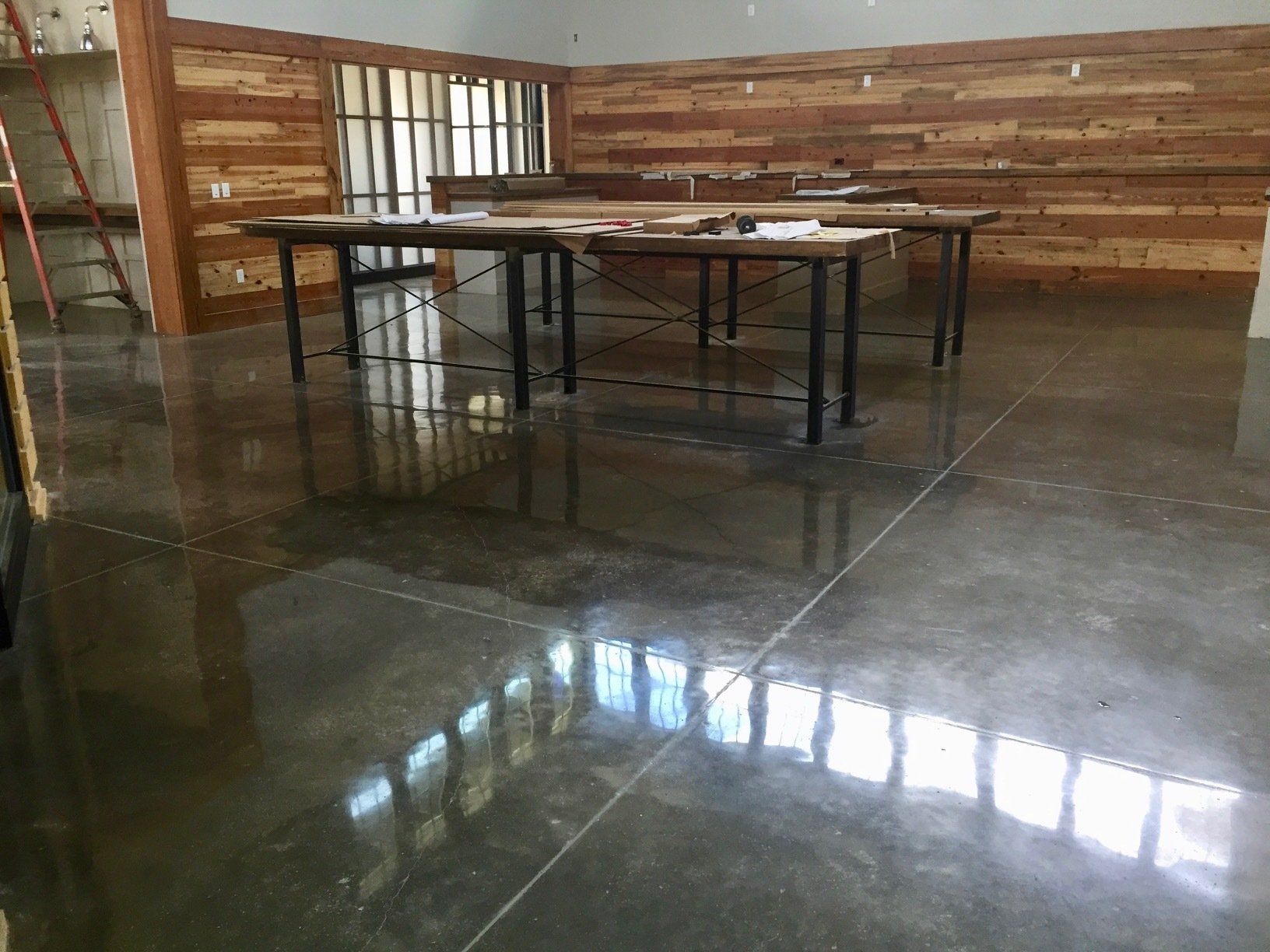 A room with tables and a wooden wall.