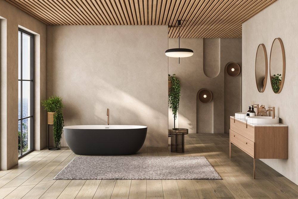 Modern spa bathroom with freestanding tub, wood ceiling, double vanity, mirrors, and soft neutral tones