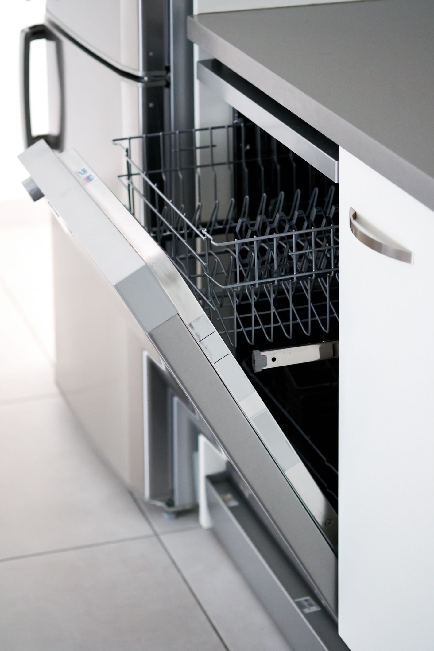 A dishwasher in a kitchen with the door open