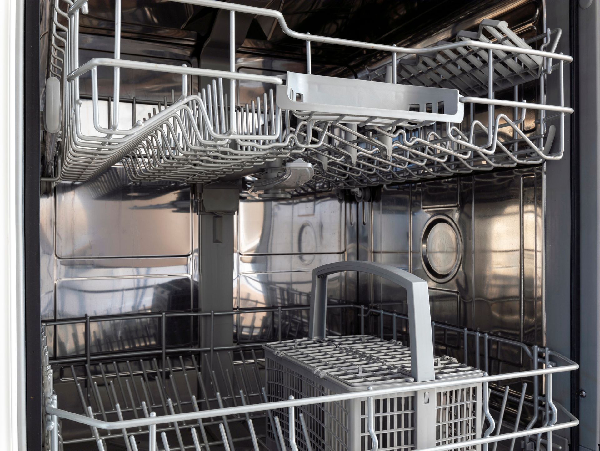 The inside of an empty dishwasher with the door open