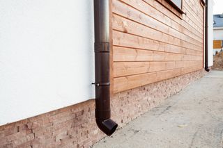 Wood Siding Lumber — Copper Gutter And A Wall Made Out Of Wood in Houston, TX
