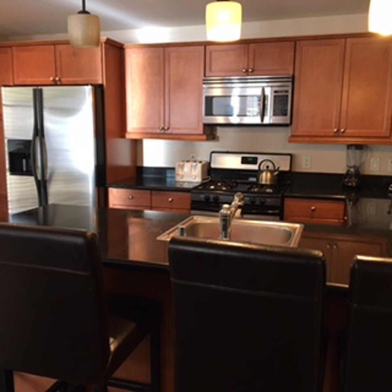 A kitchen with stainless steel appliances and wooden cabinets