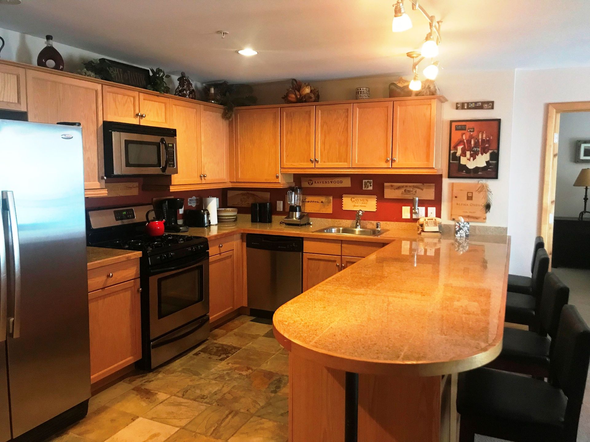 A kitchen with stainless steel appliances and wooden cabinets