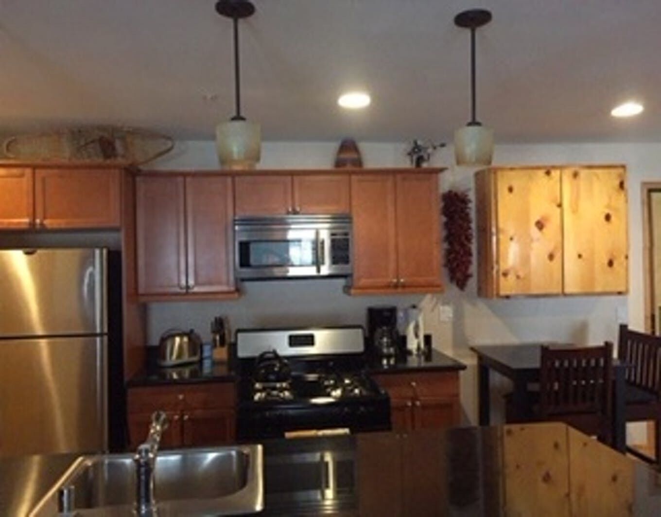 A kitchen with stainless steel appliances and wooden cabinets