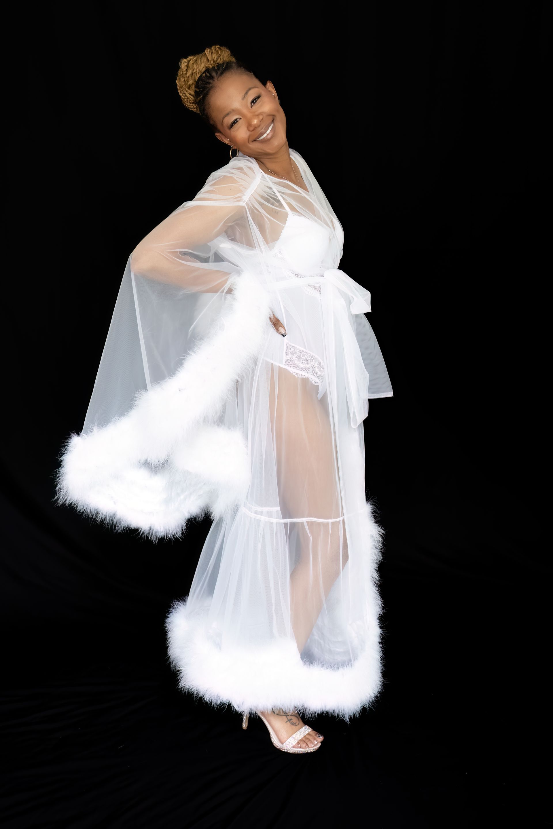 A woman is wearing a white robe with white fur trim.