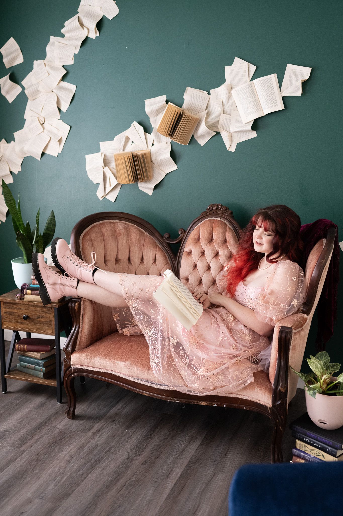 A woman is sitting on a couch reading a book.