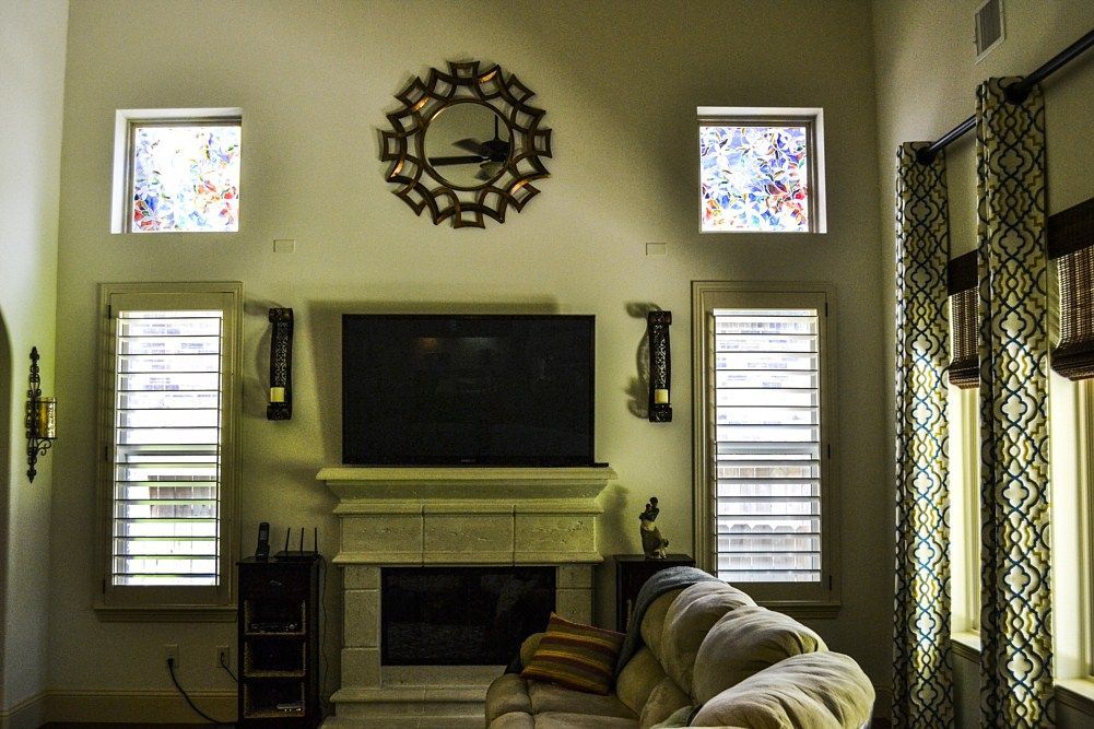 A living room with a fireplace and a flat screen tv