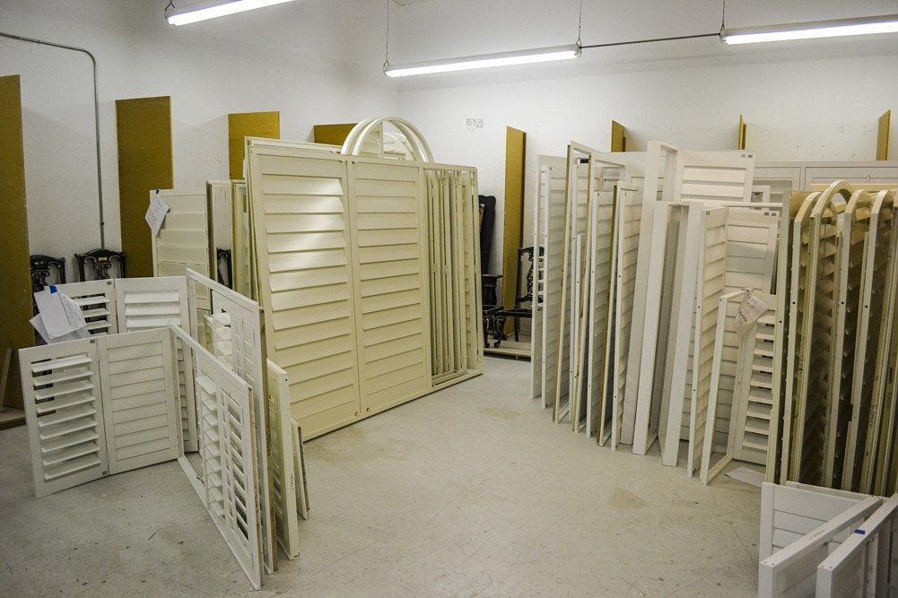 A large room filled with lots of white shutters