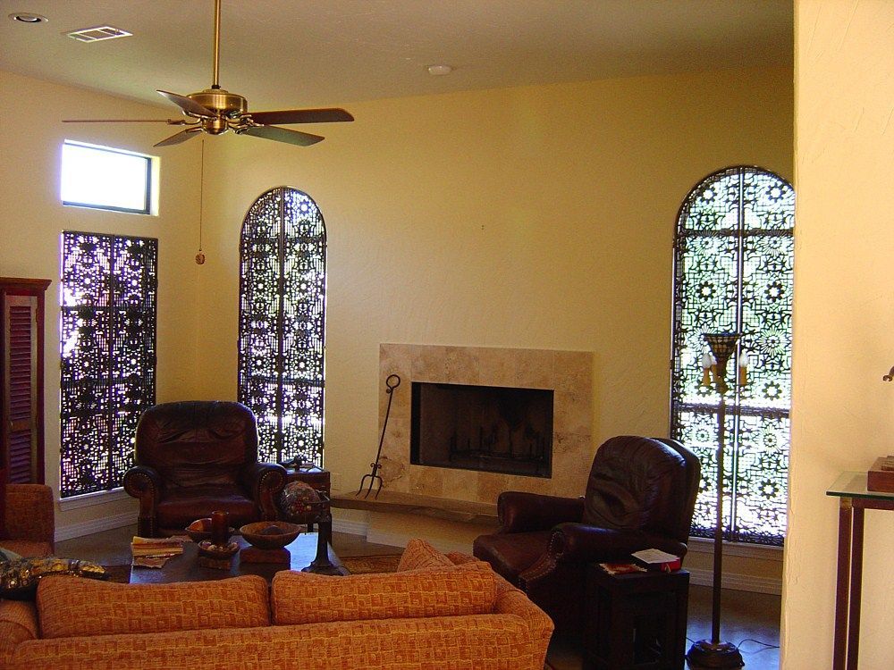 A living room with a fireplace and a ceiling fan