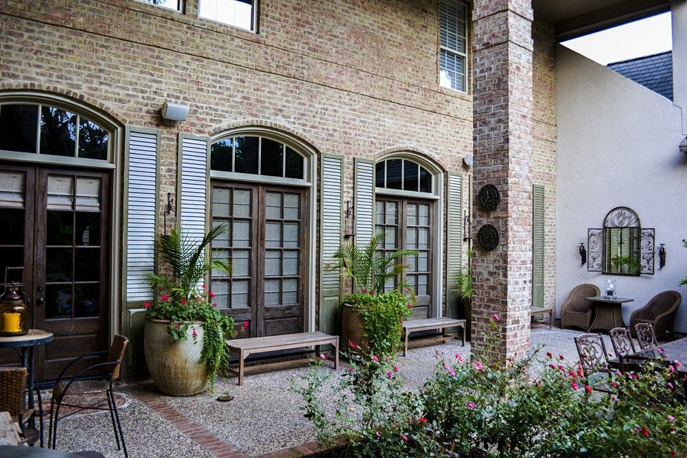 A large brick building with a patio in front of it.