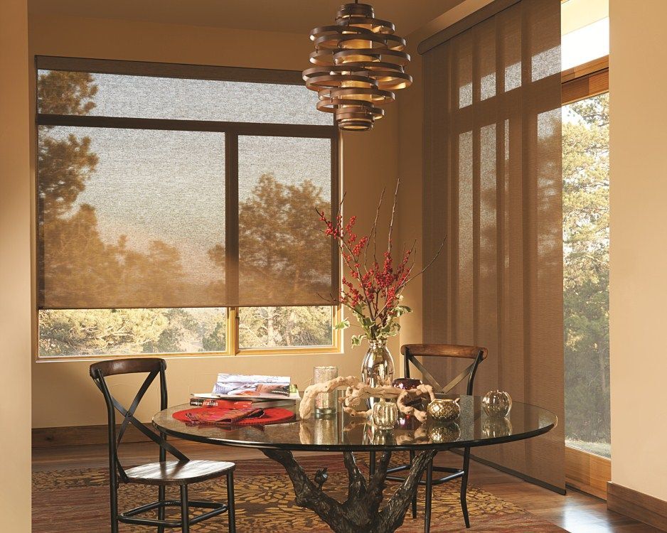 A dining room with a glass table and chairs