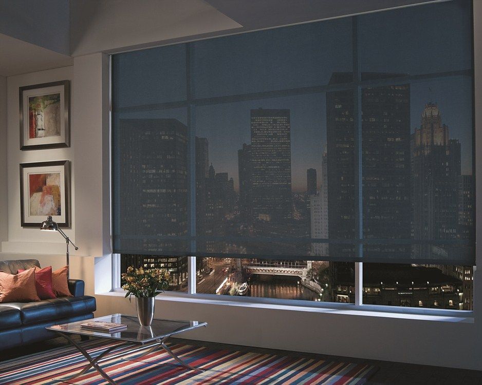 A living room with a view of the city at night