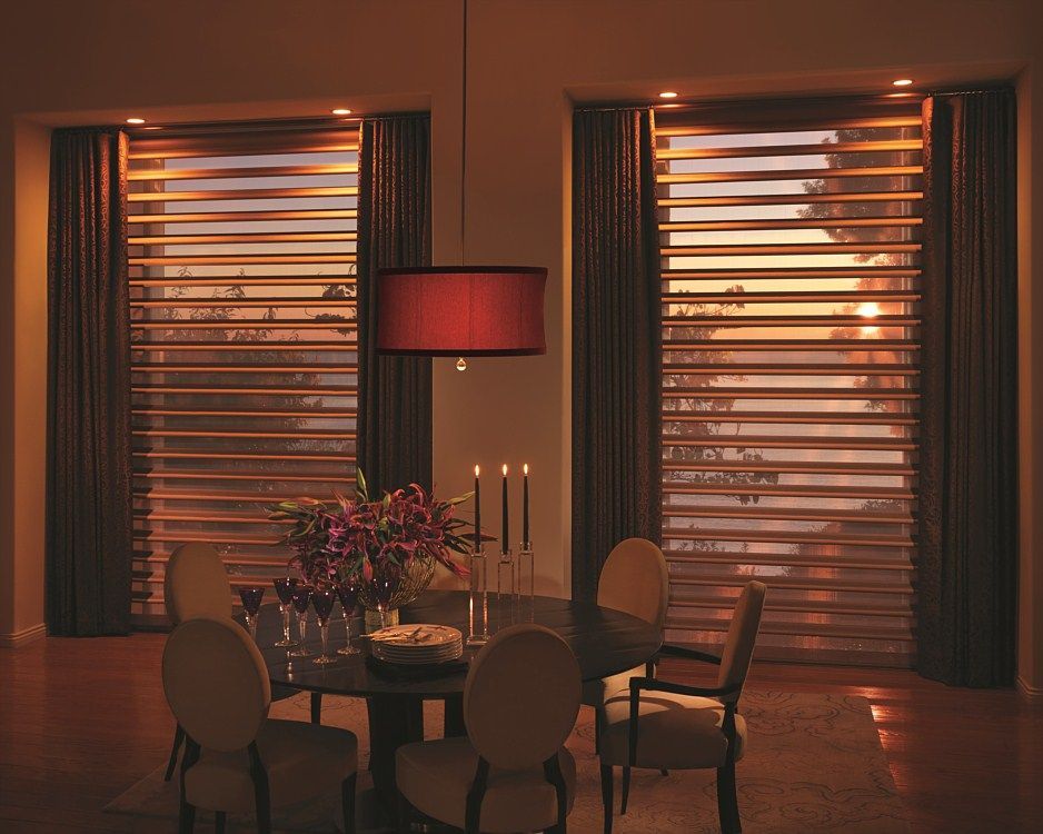 A dining room with a table and chairs and a red lamp