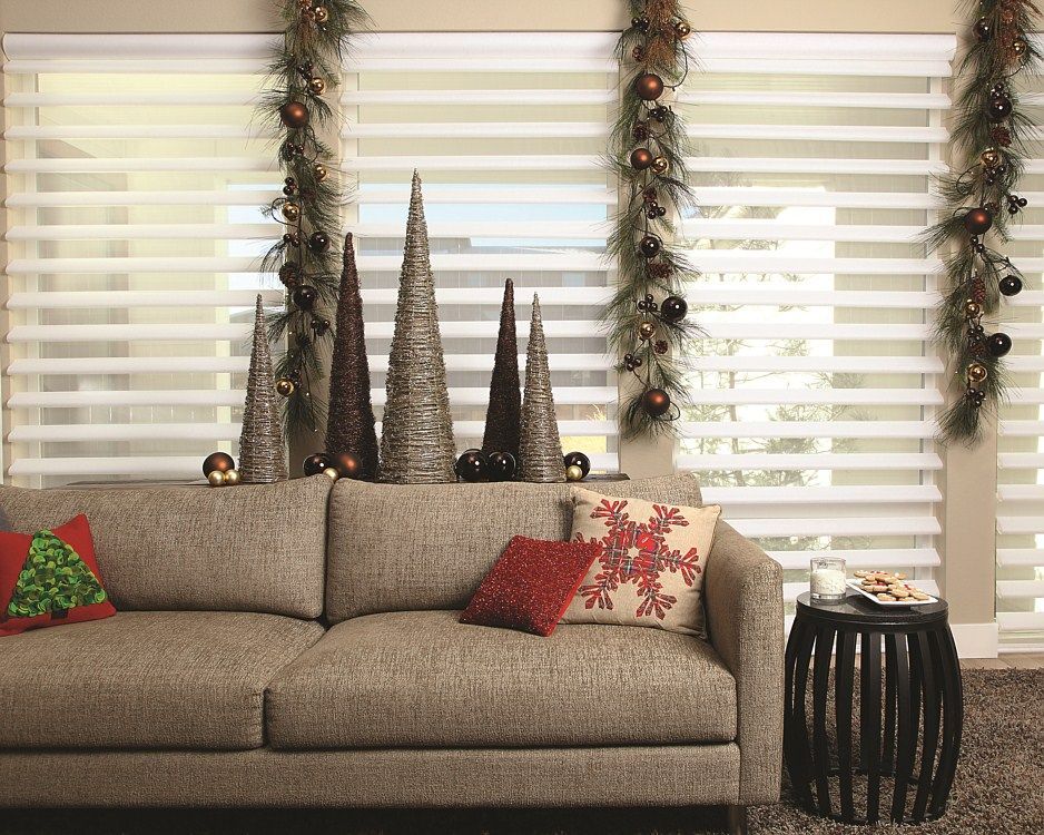 A living room decorated for christmas with a couch and a table