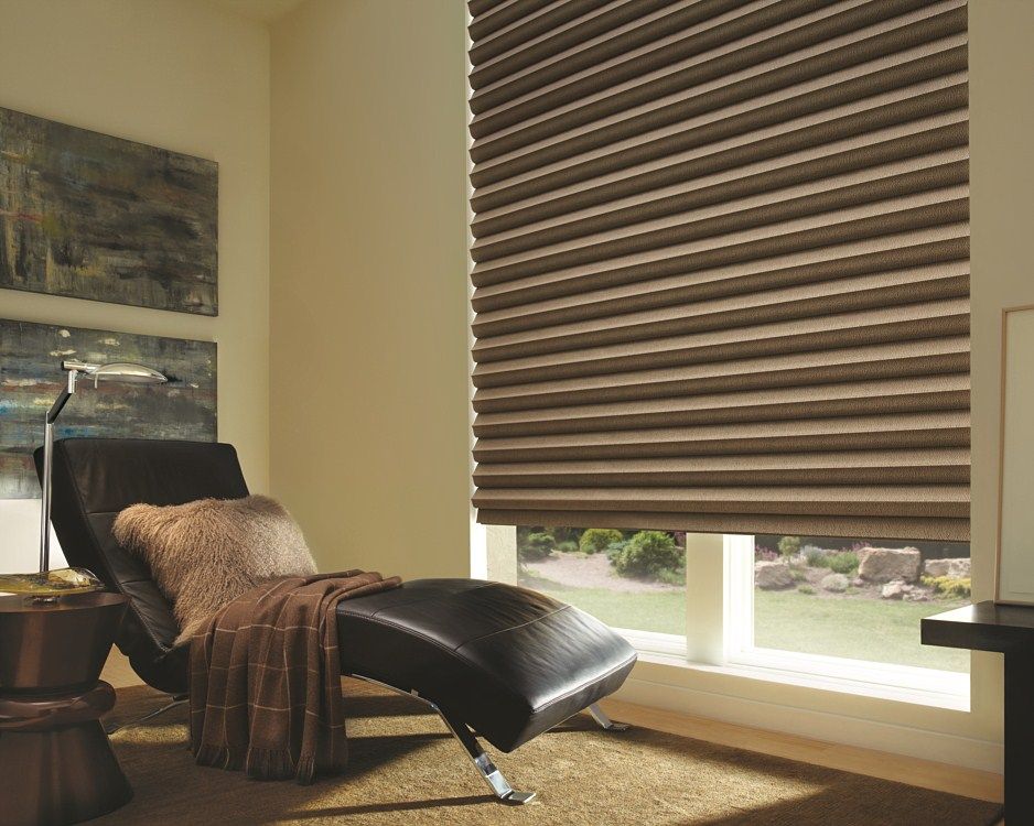 A living room with a chair and a window with blinds