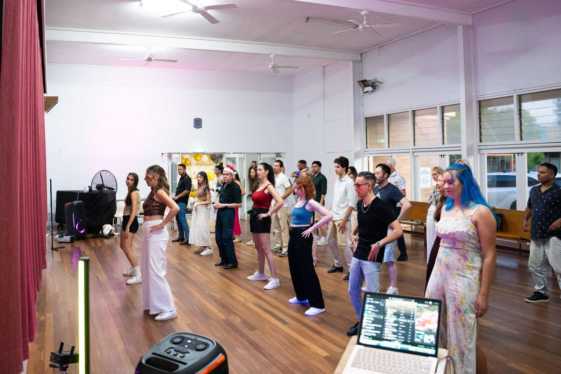 A group of people are dancing in a dance studio.