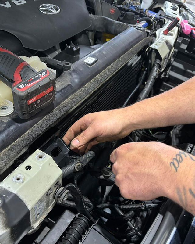 A Man Is Working On The Refrigeration On The Car — Autocool Air Conditioning in Raymond Terrace, NSW