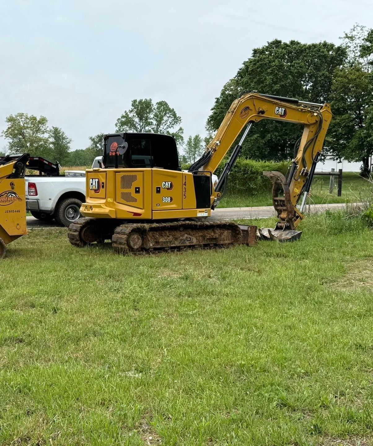 A large pile of dirt is sitting next to a road in a field.