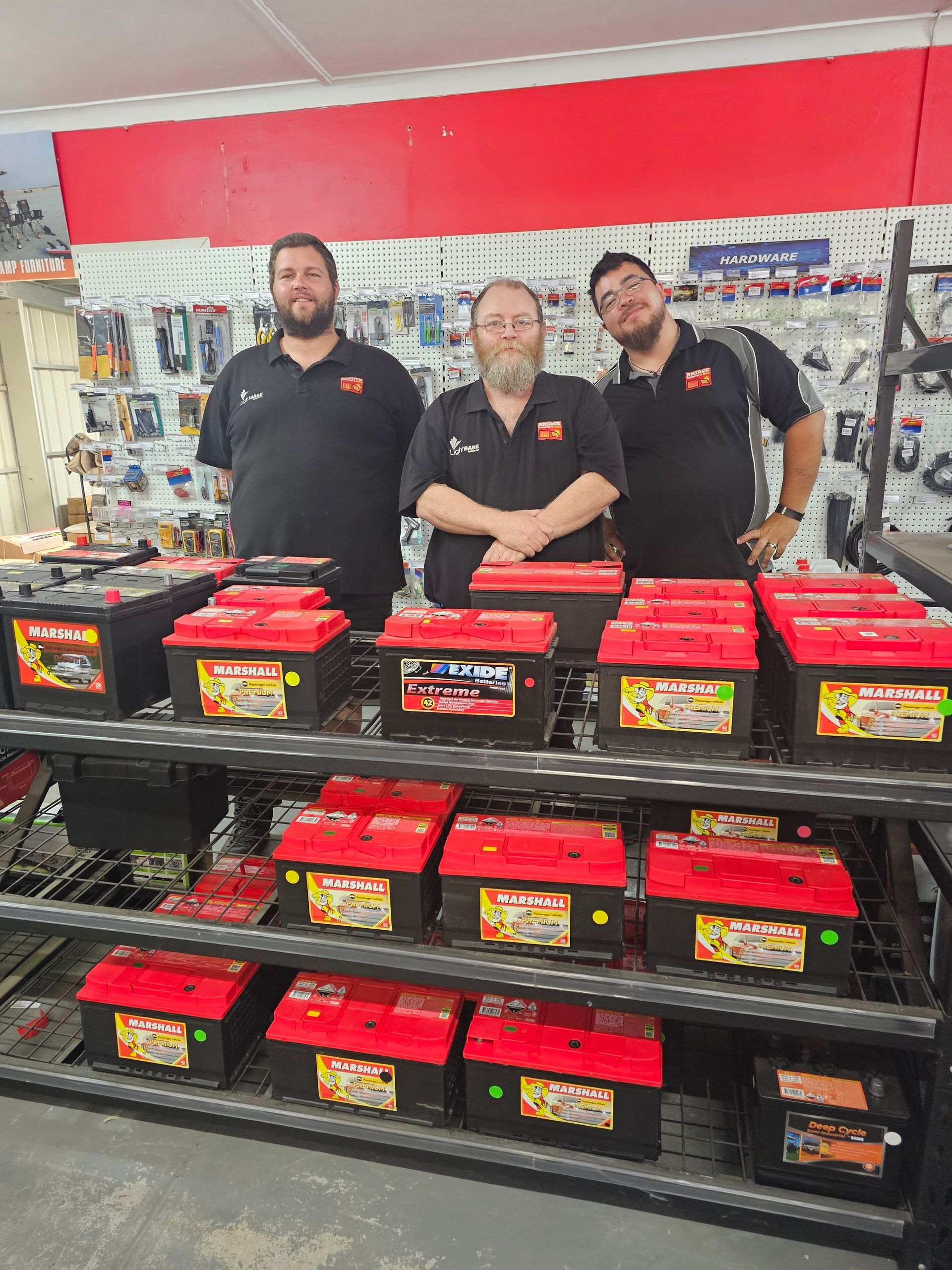 A group of people are posing for a picture in a store.
