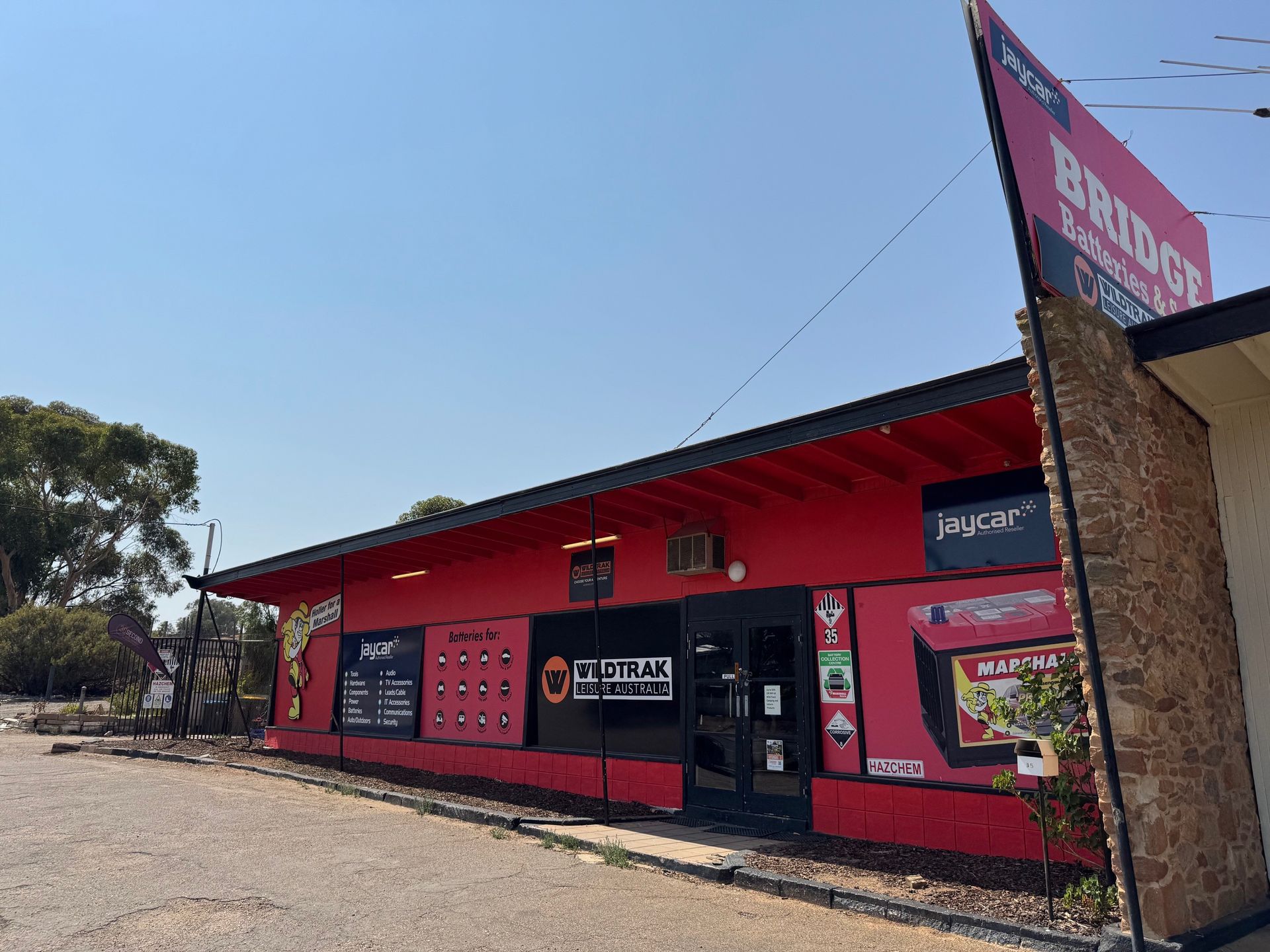 A red building with a sign that says bridge on it