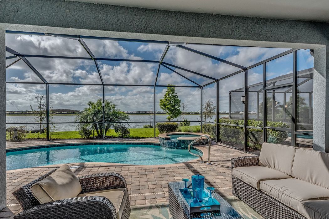 There is a swimming pool in the backyard of a house.