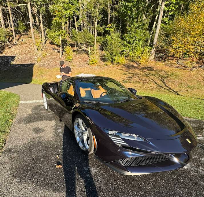 A black sports car is parked on the side of the road