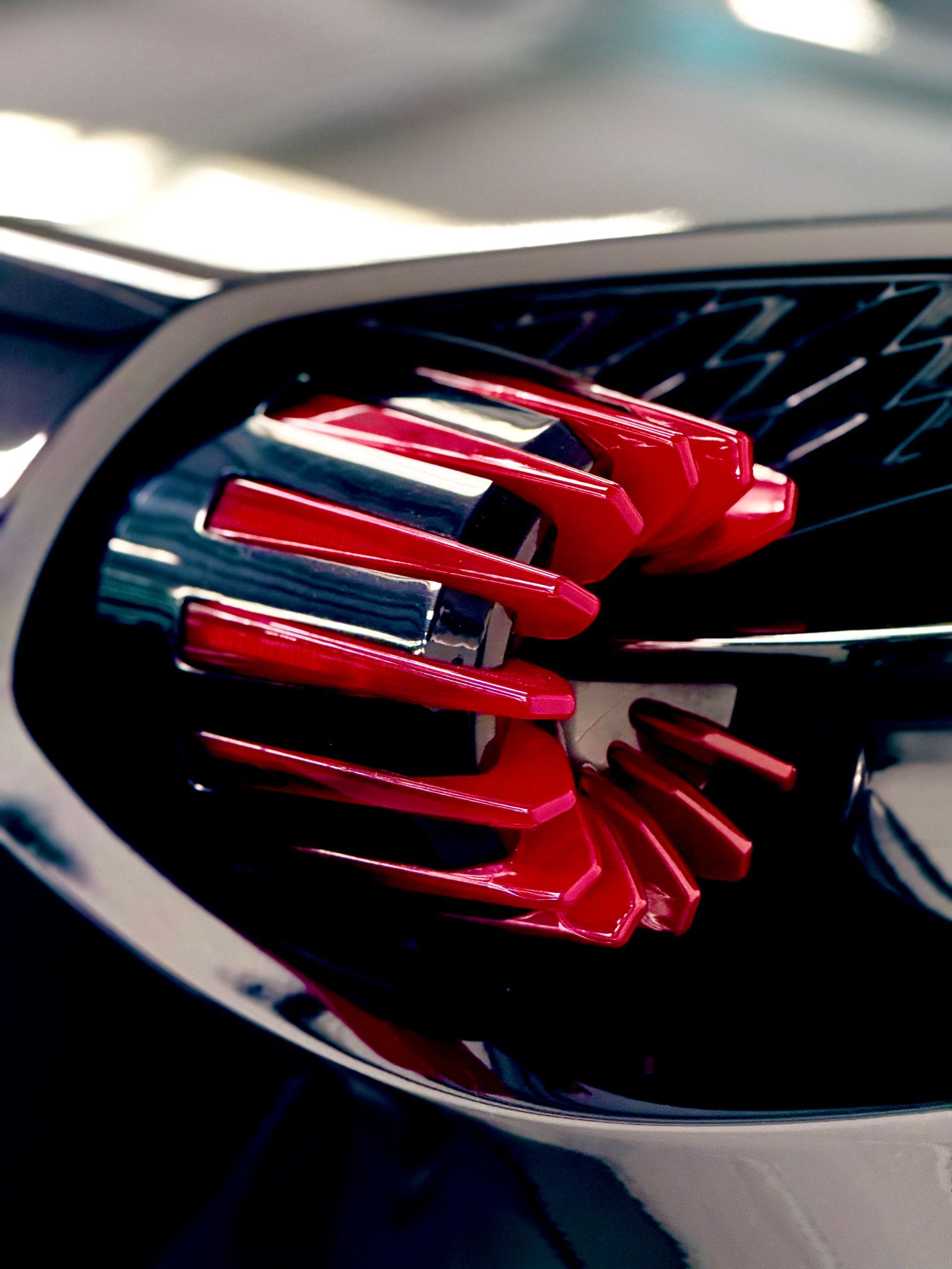 A close up of a black car with red lights