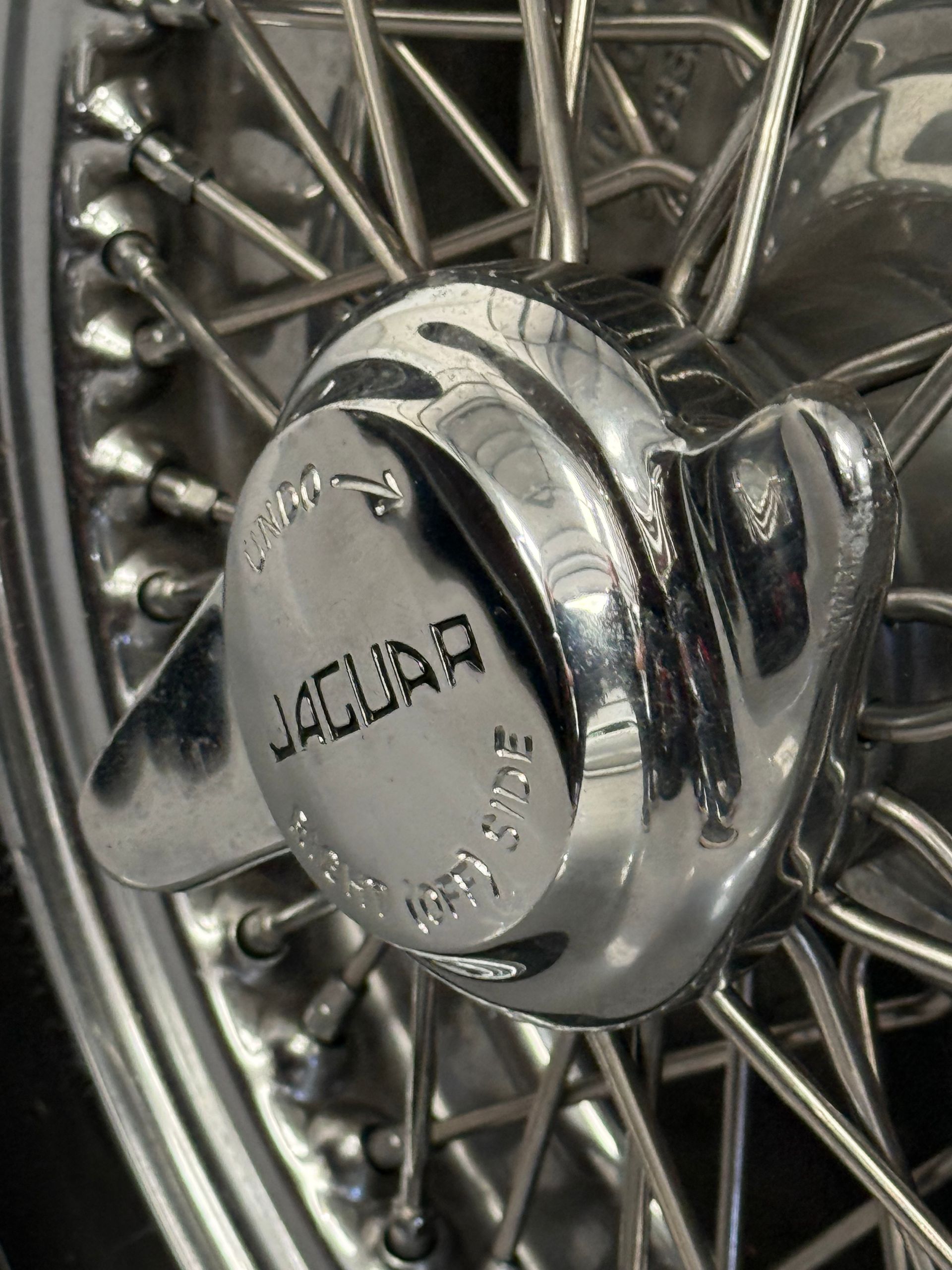 A close up of a jaguar wheel on a car