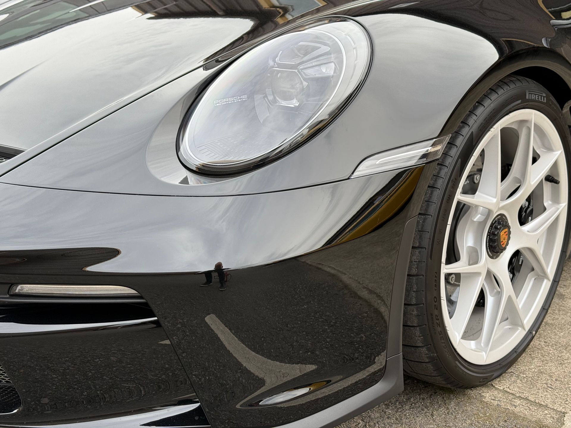 A close up of a black car with white wheels